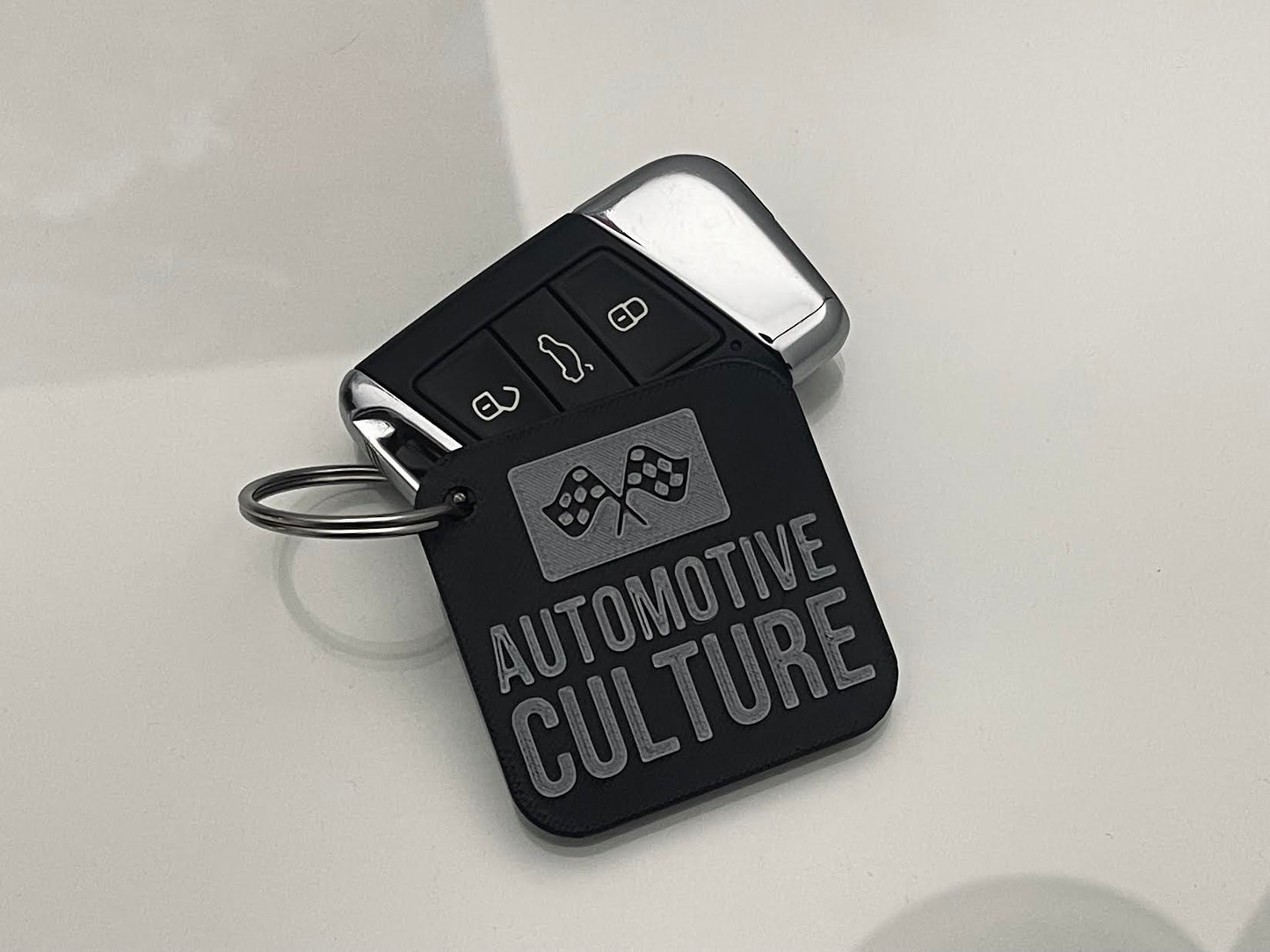 Automotive Culture logo keychain on a car key, showcasing passion for automotive culture, stylish and durable.