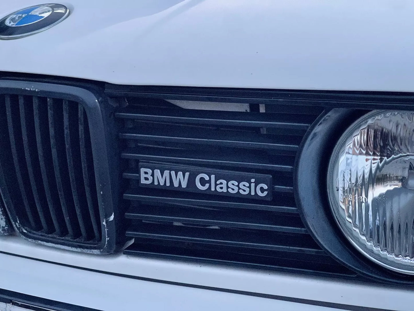 BMW Classic Emblem front view showing glossy finish and iconic BMW design