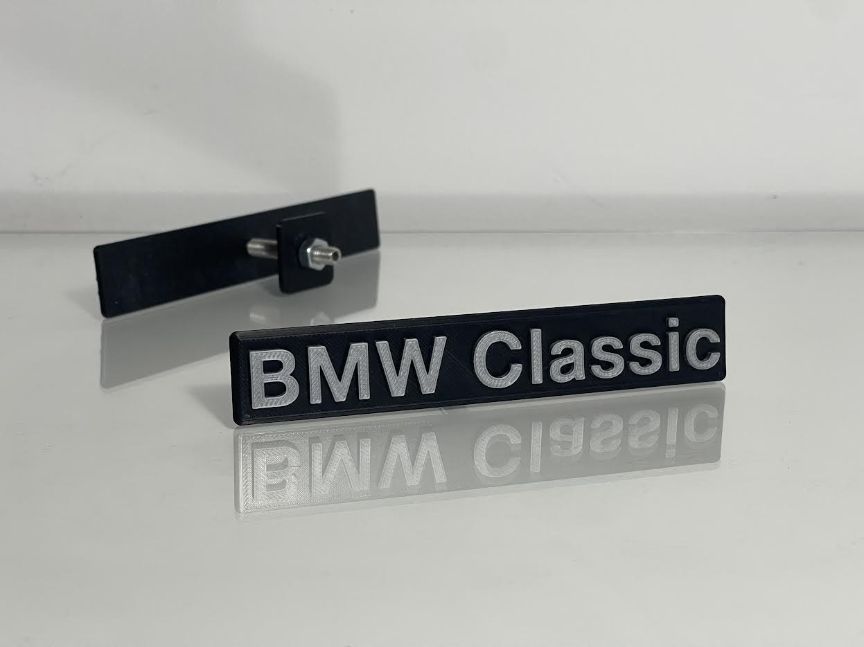 BMW Classic Emblem rear view showing adhesive backing or mounting pins