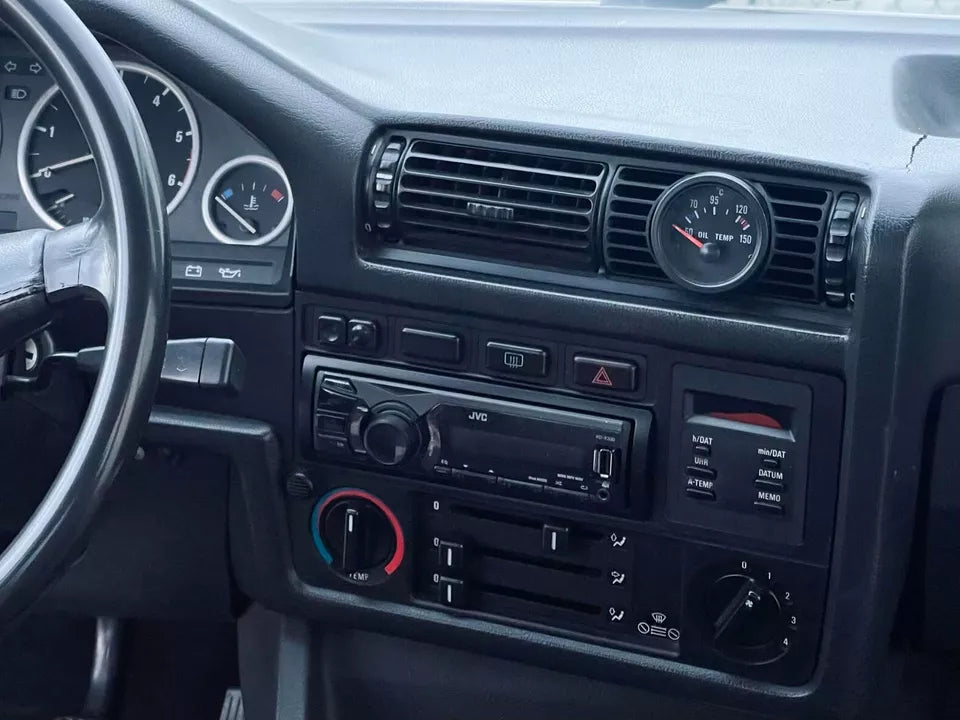 Close-up of BMW E30 center gauge pod, showing precise fitment in the center console