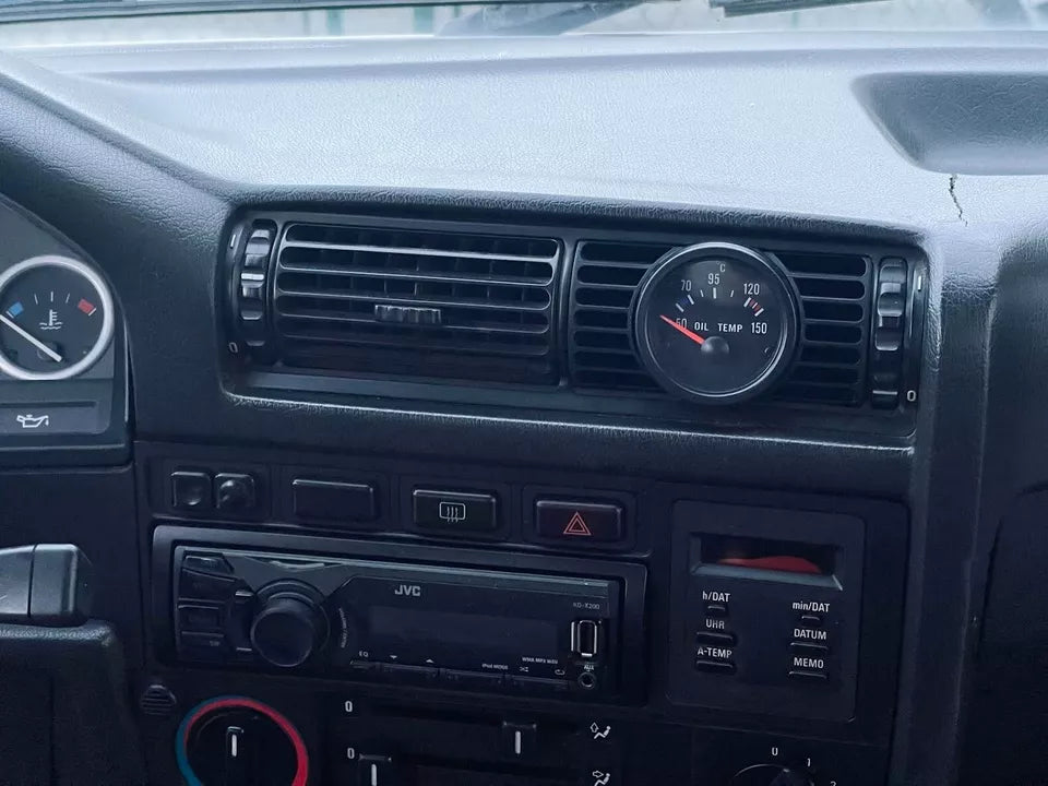 Alternative angle of BMW E30 center gauge pod installed in the dashboard, seamless OEM look.