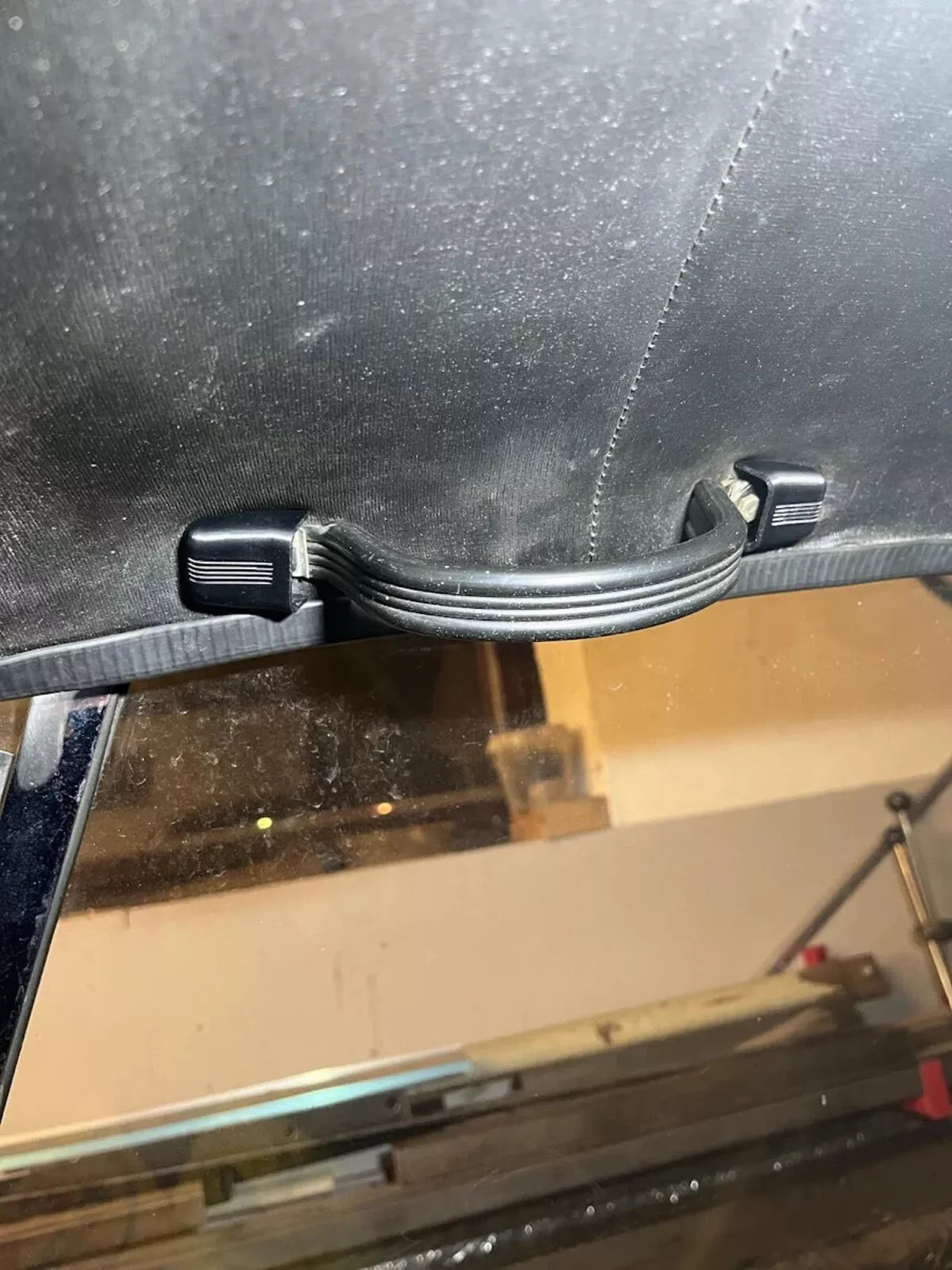 Close-up of Škoda 110R Grab Handle Cover installed in the car